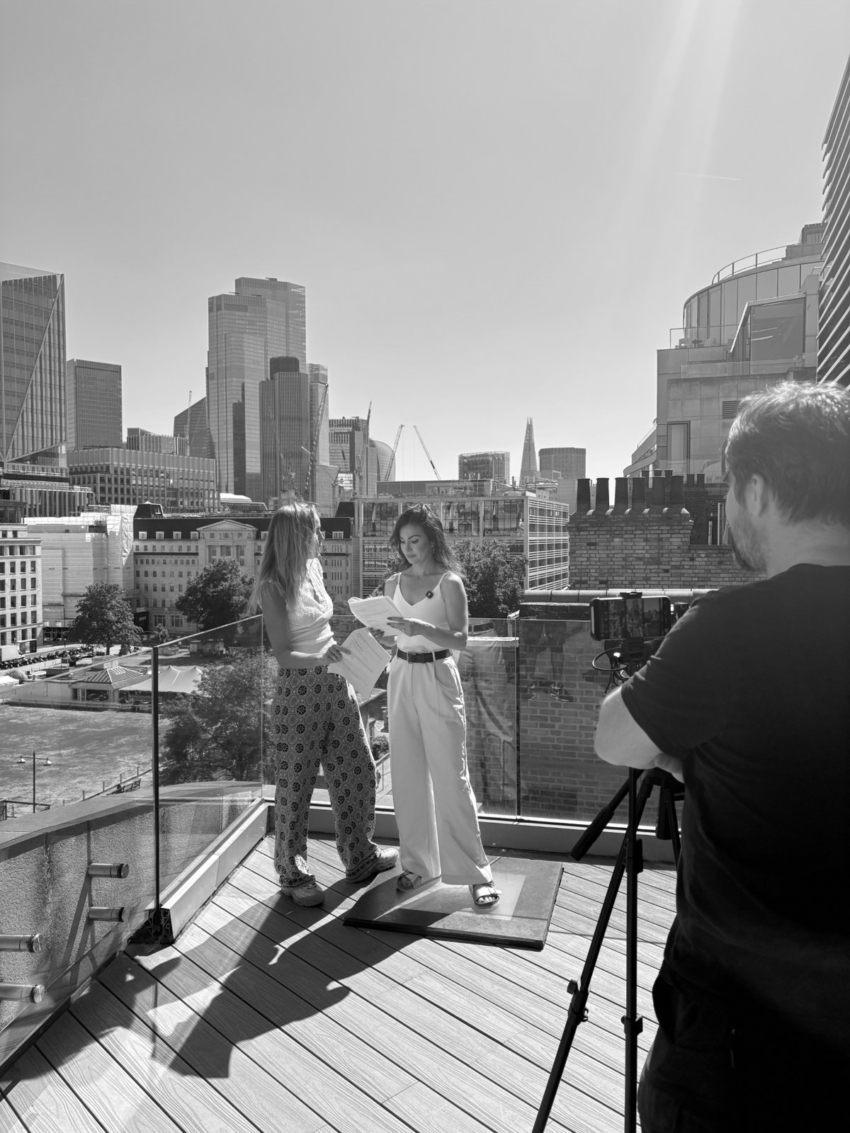 Three women talking on a London rooftop during a shoot
