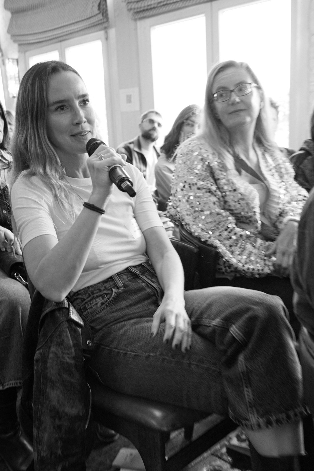 Alice Coulthard speaking with a microphone at an industry event